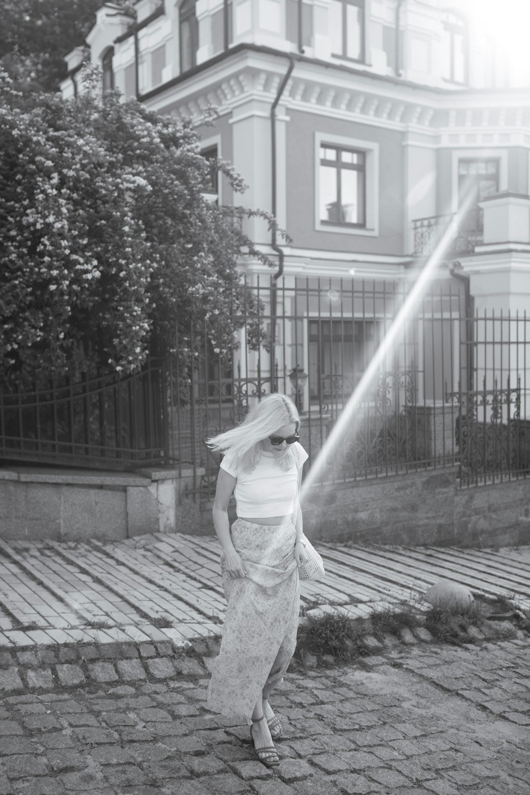 Woman walking on a cobblestone city street